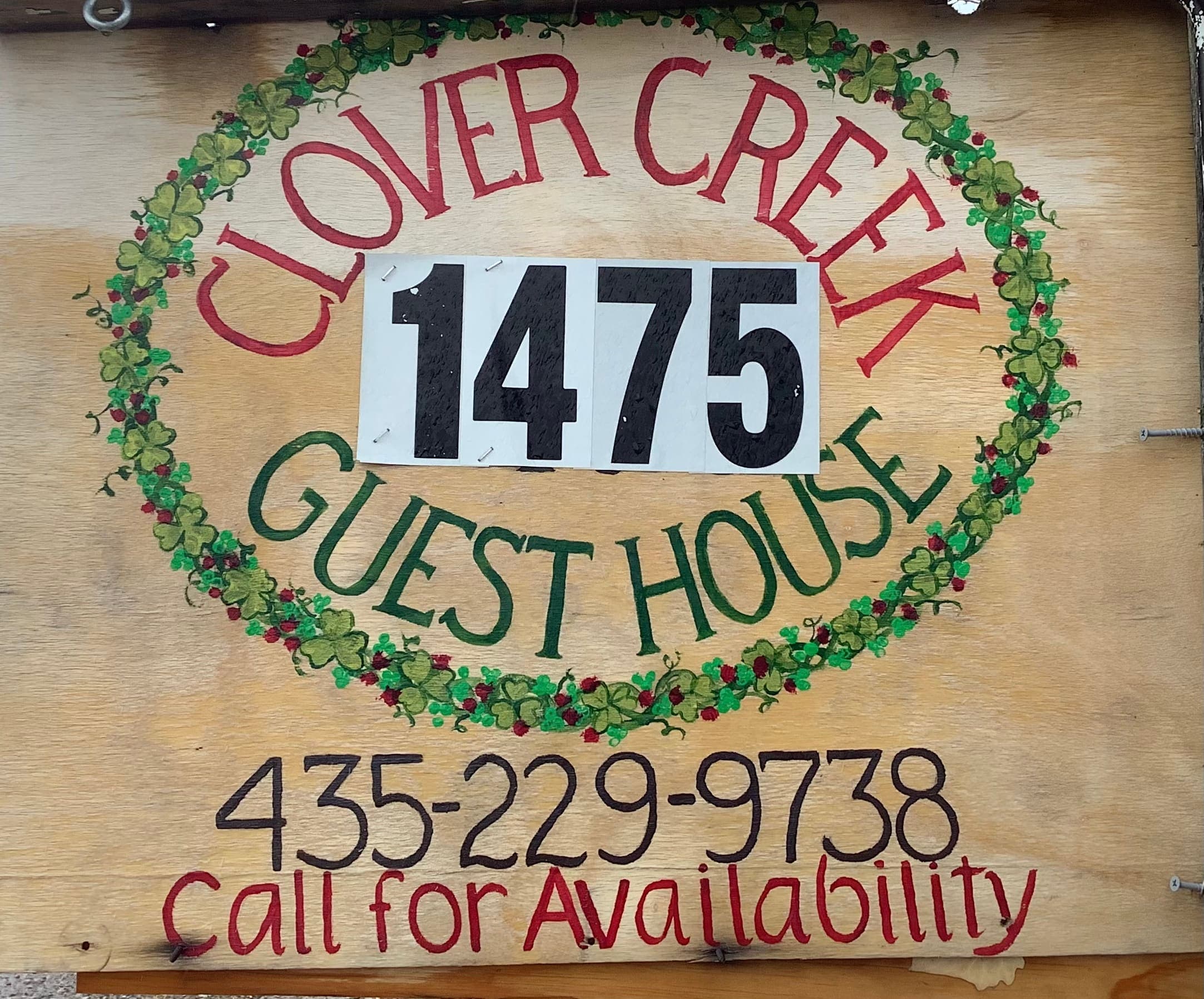Wooden welcome sign for Clover Creek Guest House at 1475, with the phone number for availability in Rush Valley, Utah